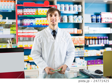 Male pharmacist in drugstore. 24771425