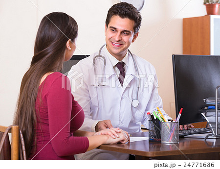 Patient and therapeutist at desk in clinic. Patient and therapeutist at desk in clinic. 24771686