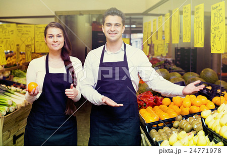 Positive smiling sellers offering good price for fruits 24771978