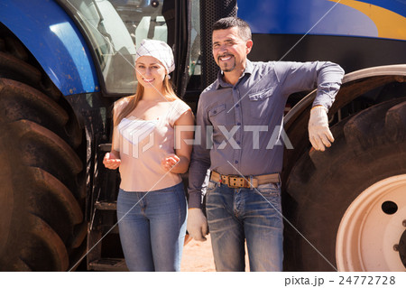 Two farmers near field engine 24772728