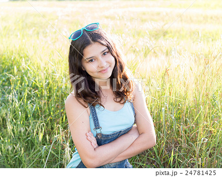 Portrait of positive teen girl outdoors in summer Portrait of positive teen girl outdoors in summer 24781425