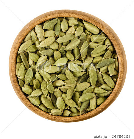 Cardamom pods in a bowl over white 24784232