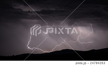 Lightning strike over mountain range Lightning strike over mountain range 24784263