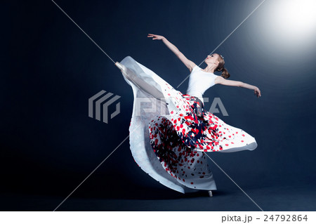 Young ballerina is dancing in a dark photostudio 24792864