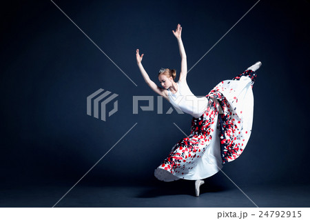 Young ballerina is dancing in a dark photostudio Young ballerina is dancing in a dark photostudio 24792915