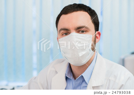 cheerful doctor with stethoscope and surgical mask cheerful doctor with stethoscope and surgical mask 24793038