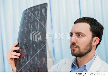 Doctor viewing MRI scans at his office Doctor viewing MRI scans at his office 24793089
