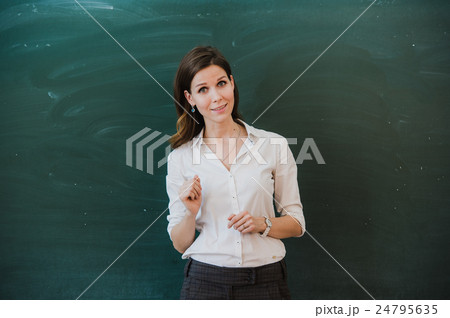 Woman pointing finger at blank board. School Woman pointing finger at blank board. School 24795635