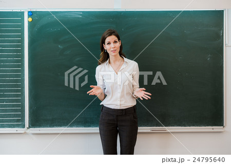 Woman pointing finger at blank board. School 24795640