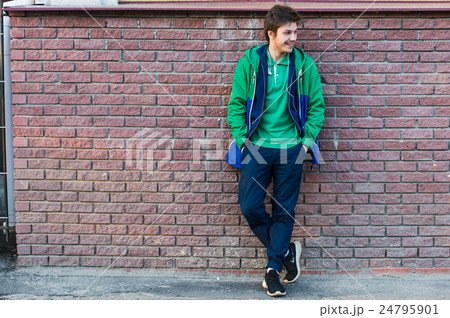 Common young man wearing green t-shirt jacket and Common young man wearing green t-shirt jacket and 24795901