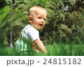 Baby sits on a grass 24815182