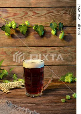 Beer dark lager, brown ale on wooden table in bar or pub Beer dark lager, brown ale on wooden table in bar or pub 24818951