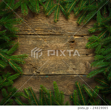 Christmas tree branches on wooden texture ready for your design Christmas tree branches on wooden texture ready for your design 24819065