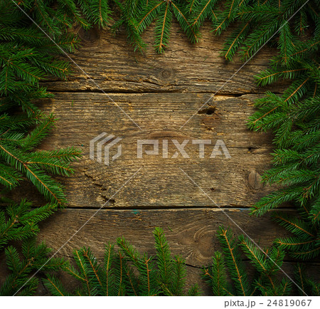 Christmas tree branches on wooden texture ready for your design Christmas tree branches on wooden texture ready for your design 24819067