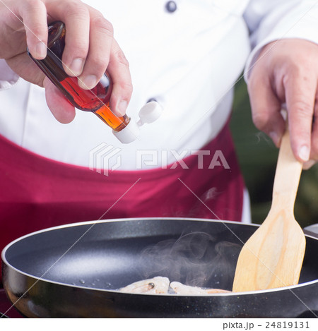 Chef putting fish sauce for cooking Pad Thai Chef putting fish sauce for cooking Pad Thai 24819131