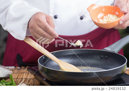 Chef putting minced garlic for cooking Pad Thai Chef putting minced garlic for cooking Pad Thai 24819132