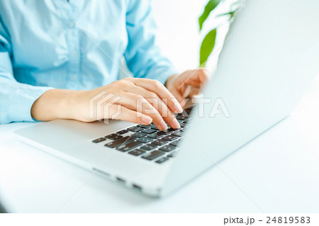 Woman office worker typing on the keyboard Woman office worker typing on the keyboard 24819583