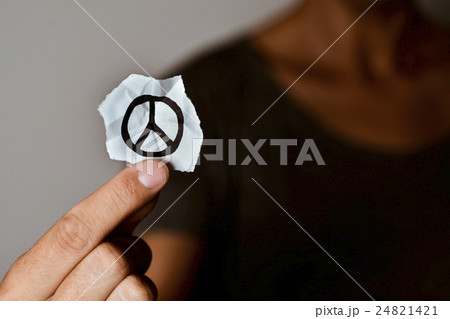 man with a peace symbol in a piece of paper 24821421