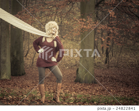 Fashion woman in windy fall autumn park forest. 24822841