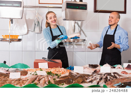 Ordinary fish and seafood store with two sellers indoors 24826488