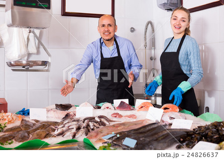 Two sellers in fish store . 24826637