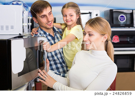 Portrait of family selecting microwave 24826859