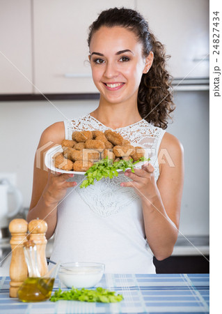 woman posing with plate of deep-fried kroketten 24827434
