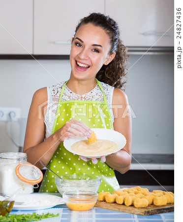 housewife cooking breadcrumbed croquettes 24827436