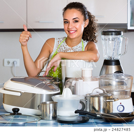 Girl with kitchen appliances at home. Girl with kitchen appliances at home. 24827485