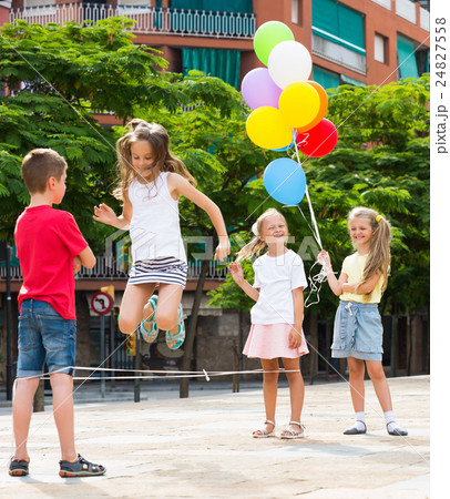 Kids skipping on elastic rope 24827558