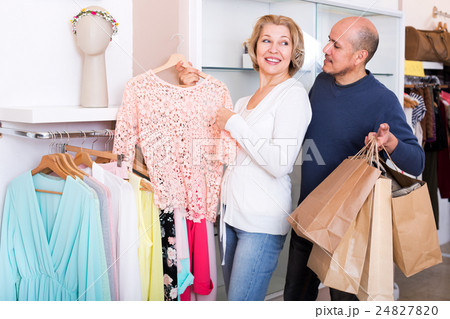 Elderly spouses buying new blouse in boutique 24827820