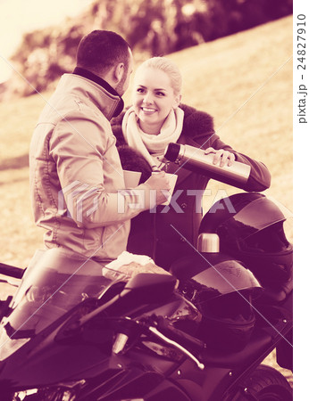 Couple posing near motor bike Couple posing near motor bike 24827910