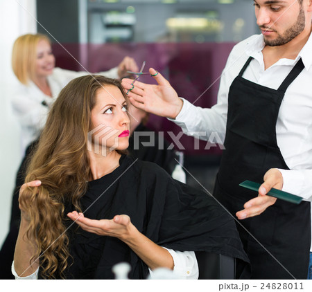 Displeased client and hairdresser. Displeased client and hairdresser. 24828011