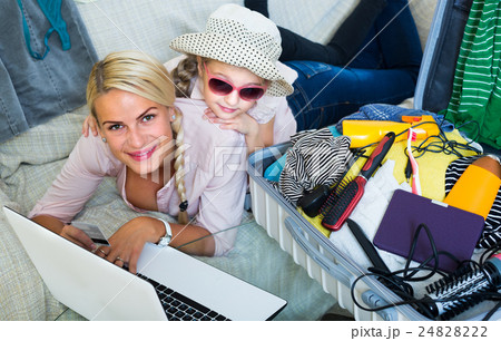 Family of two buying tickets online. Family of two buying tickets online. 24828222