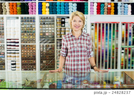 Woman seller standing in sewing store 24828237