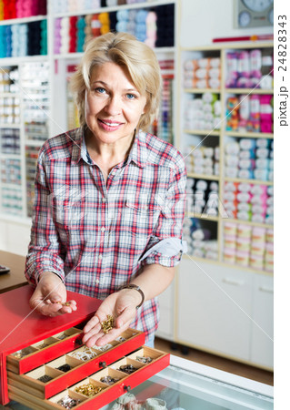 mature woman customer in sewing store. 24828343