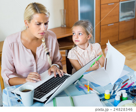 Stressed woman with child working from home . 24828346