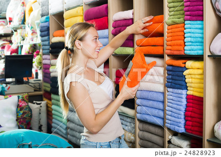 Happy female customer choosing towels 24828923
