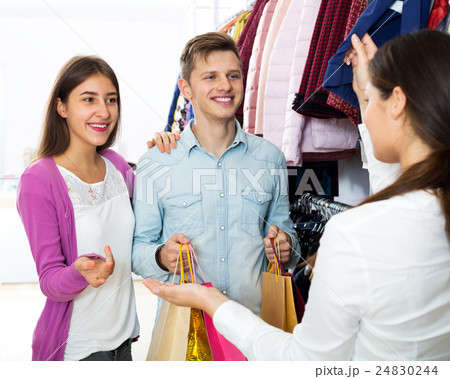 Female assistant serving happy customers Female assistant serving happy customers 24830244