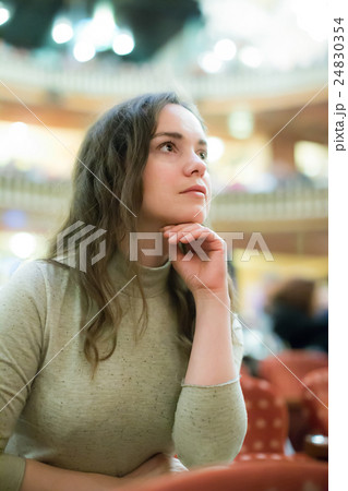 Happy woman theatre goer looking at play Happy woman theatre goer looking at play 24830354