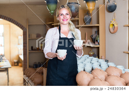 nice female artisan having ceramics in workshop nice female artisan having ceramics in workshop 24830364