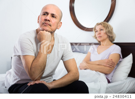 Mature couple having quarrel in bedroom. Mature couple having quarrel in bedroom. 24830411