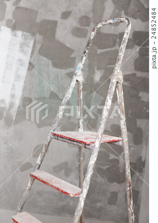 Old painted and stucco ladder on concrete wall 24852484