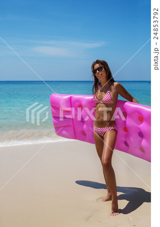 Young slim brunette woman in sunglasses sunbathe on tropical beach 24853792