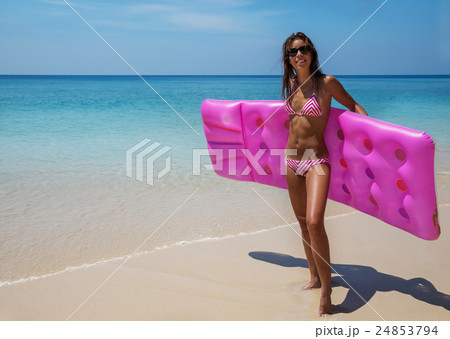 Young slim brunette woman in sunglasses sunbathe on tropical beach 24853794