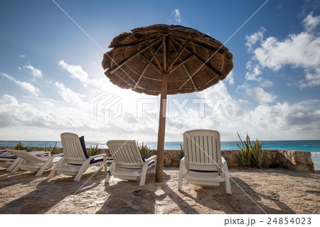 Caribbean beach with grass umbrellas and beds 24854023