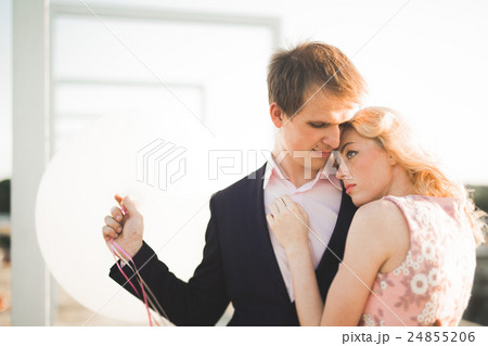Young couple in love posing on roof with perfect 24855206