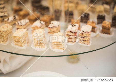 Delicious and tasty dessert table with cupcakes Delicious and tasty dessert table with cupcakes 24855723