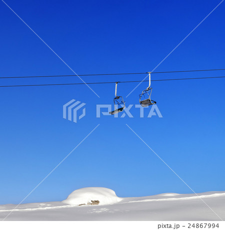 Chair-lift and blue clear sky at sunny day 24867994