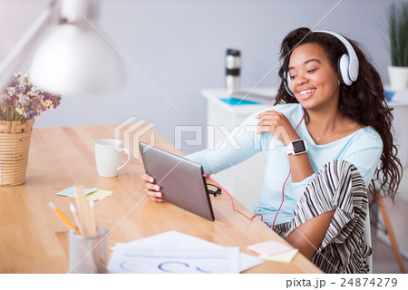 Joyful smiling woman listening to music Joyful smiling woman listening to music 24874279